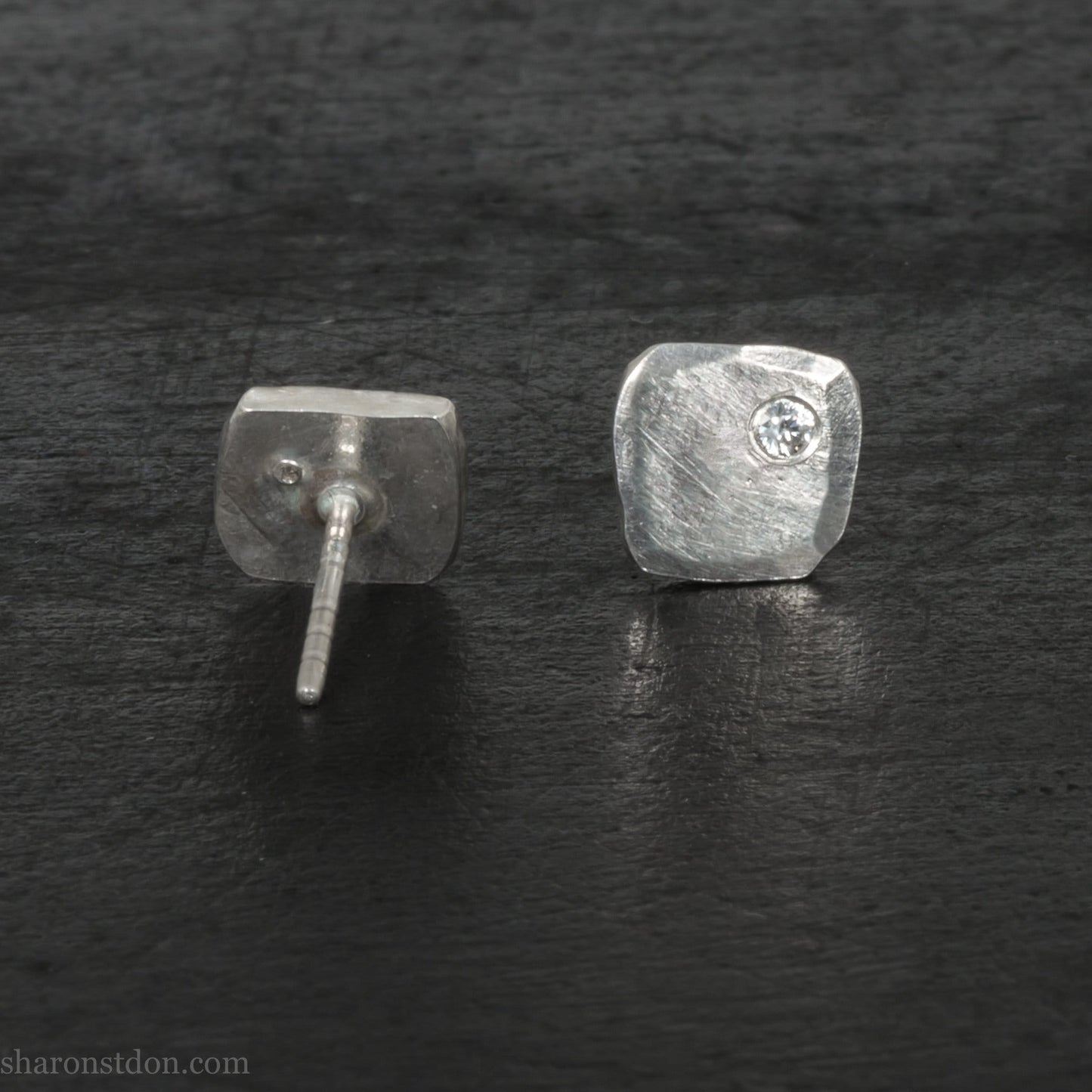 7mm square, handmade 925 sterling silver stud earrings with a Canadian diamond set in the corner. Handmade by Sharon SaintDon in North America with Canadamark diamonds.