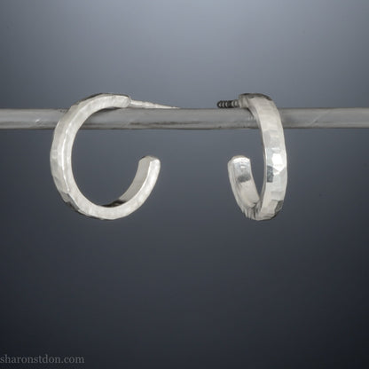 14mm x 2mm small sterling silver hoop earrings, Handmade in North America by Sharon SaintDon. Hammered texture, solid silver with silver posts and backs for men or women, unisex.