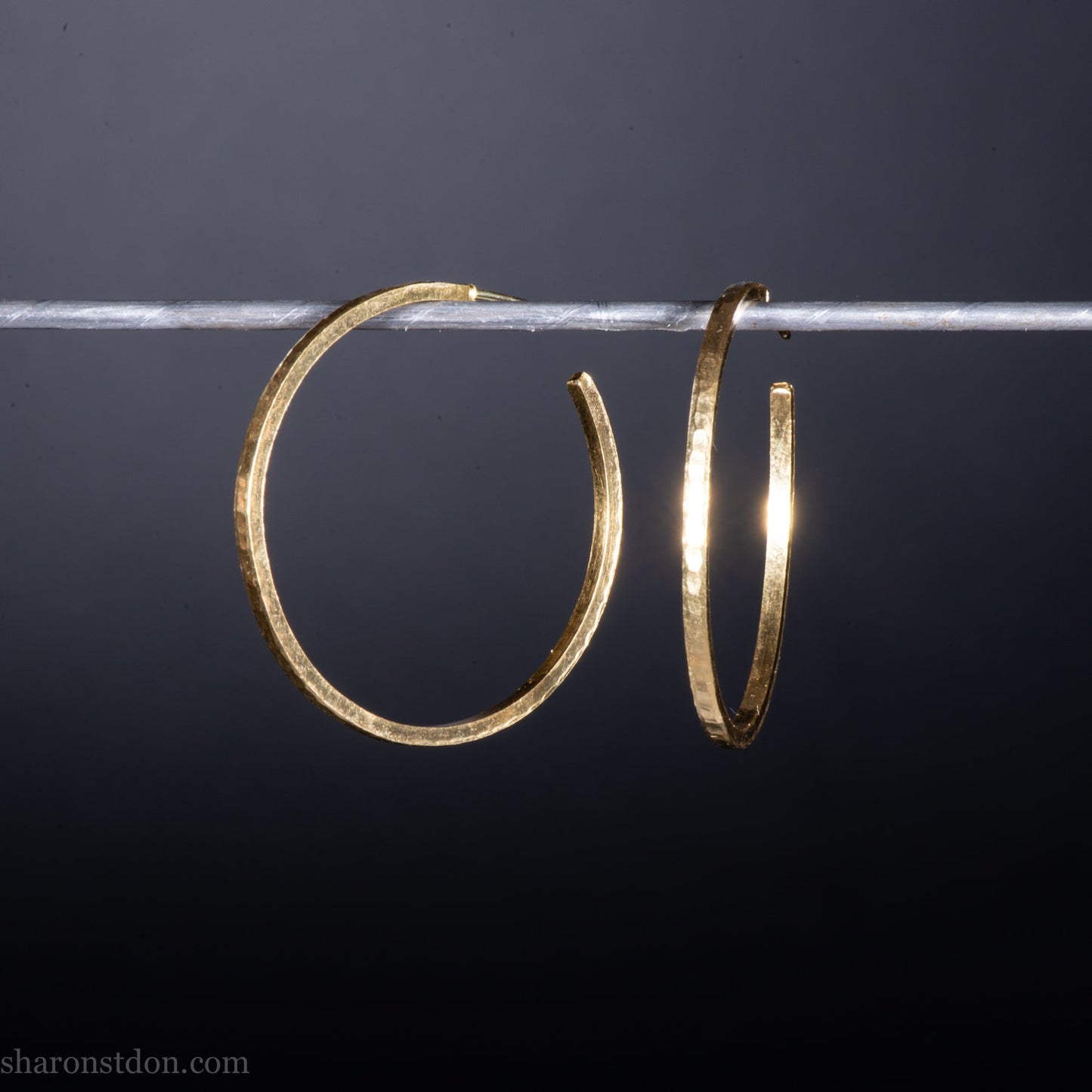 Solid 18k yellow gold hoop earrings set, handmade in North America by Sharon SaintDon.30mm diameter round, 2mm wide, 1.5mm thick, with hammered texture and matte finish.
