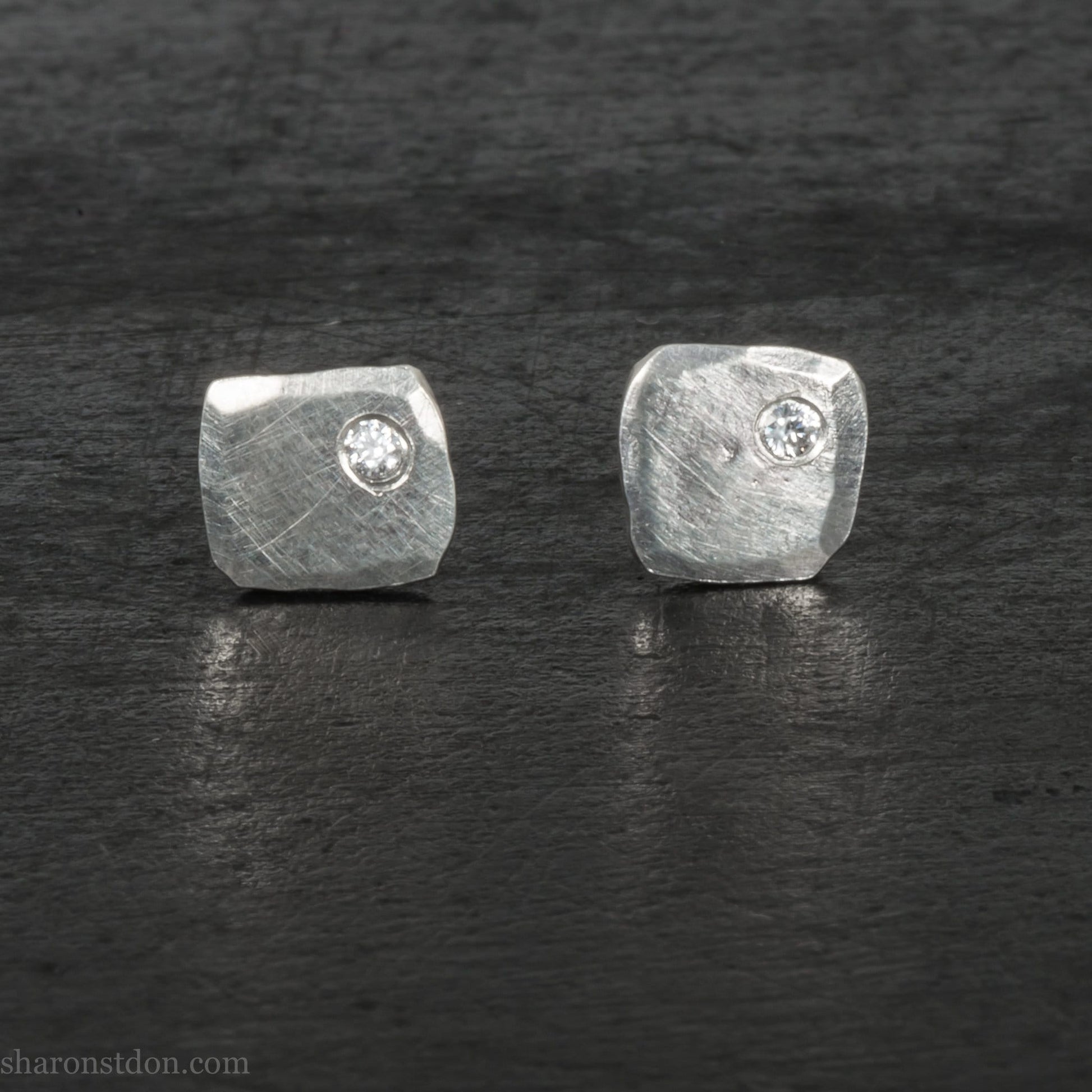7mm square 925 sterling silver stud earrings with imitation diamond in the corner. Hammered texture with a matte, shiny finish. Handmade by Sharon SaintDon in North America for men or women.