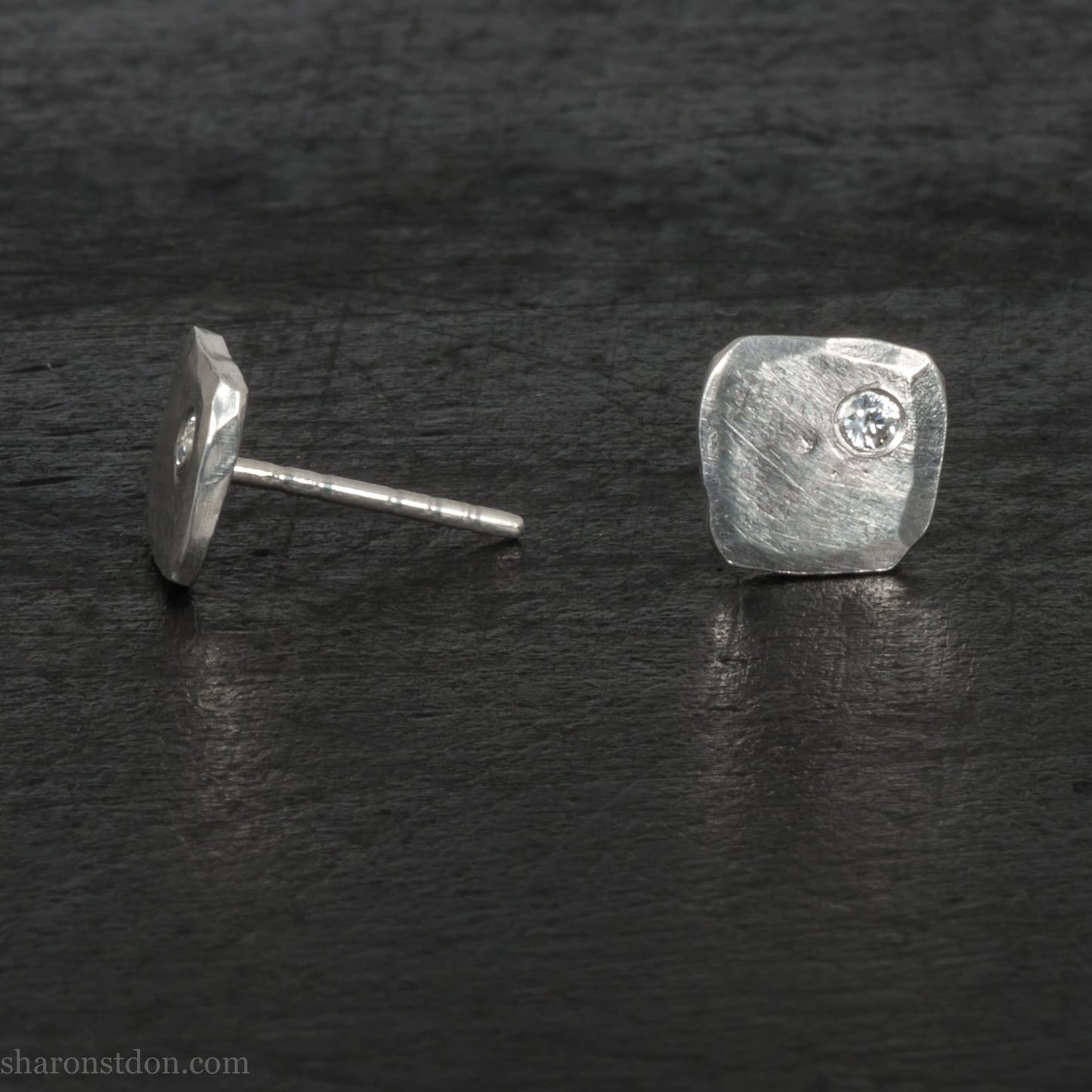 7mm square, handmade 925 sterling silver stud earrings with a Canadian diamond set in the corner. Handmade by Sharon SaintDon in North America with Canadamark diamonds.