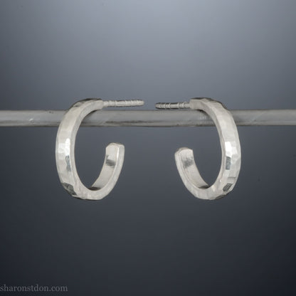 14mm x 2mm small sterling silver hoop earrings, Handmade in North America by Sharon SaintDon. Hammered texture, solid silver with silver posts and backs for men or women, unisex.