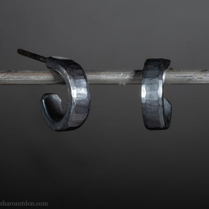 12mm x 3mm small sterling silver hoop earrings, Handmade in North America by Sharon SaintDon. Oxidized black, hammered texture, solid silver with silver posts and backs for men or women, unisex.