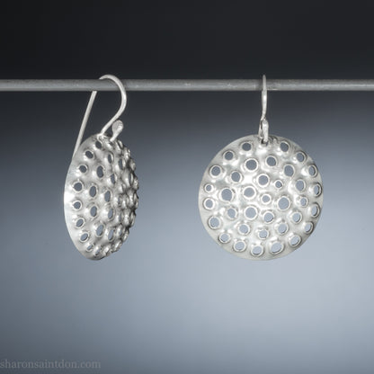 Handmade 925 sterling silver earrings for women. Round disc earrings with perforated holes made by Sharon SaintDon in North America. 25mm diameter.