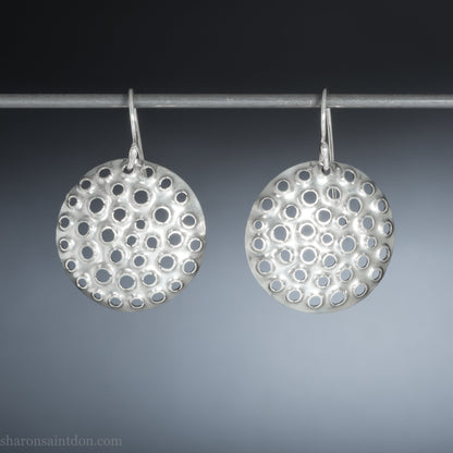 Handmade 925 sterling silver earrings for women. Round disc earrings with perforated holes made by Sharon SaintDon in North America. 25mm diameter.