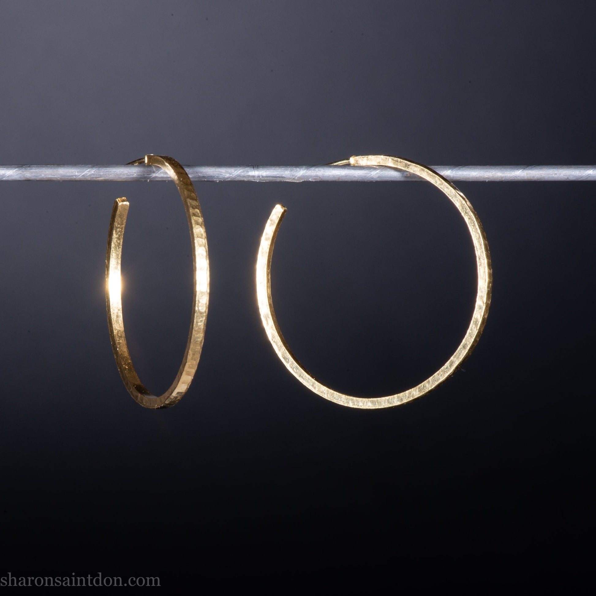 14k yellow gold hoop earrings 30mm diameter, 2mm wide, 1.5mm thick. High quality, handmade with hammered texture, solid gold posts and locking backs.