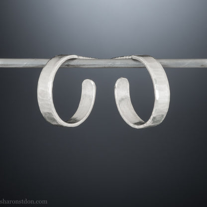 925 sterling silver hoop earrings handmade in North America by Sharon SaintDon. 18mm diameter round, 4mm wide, hammered texture, matte, brushed finish and silver posts and backs.