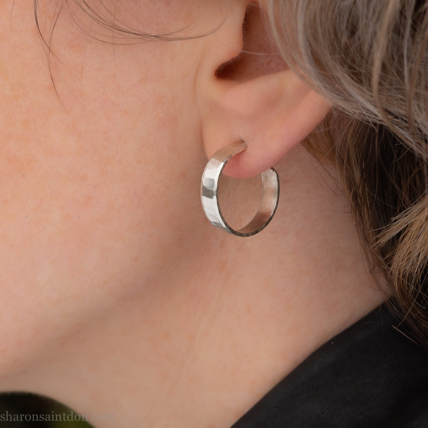 925 sterling silver hoop earrings handmade in North America by Sharon SaintDon. 18mm diameter round, 4mm wide, hammered texture, matte, brushed finish and silver posts and backs.