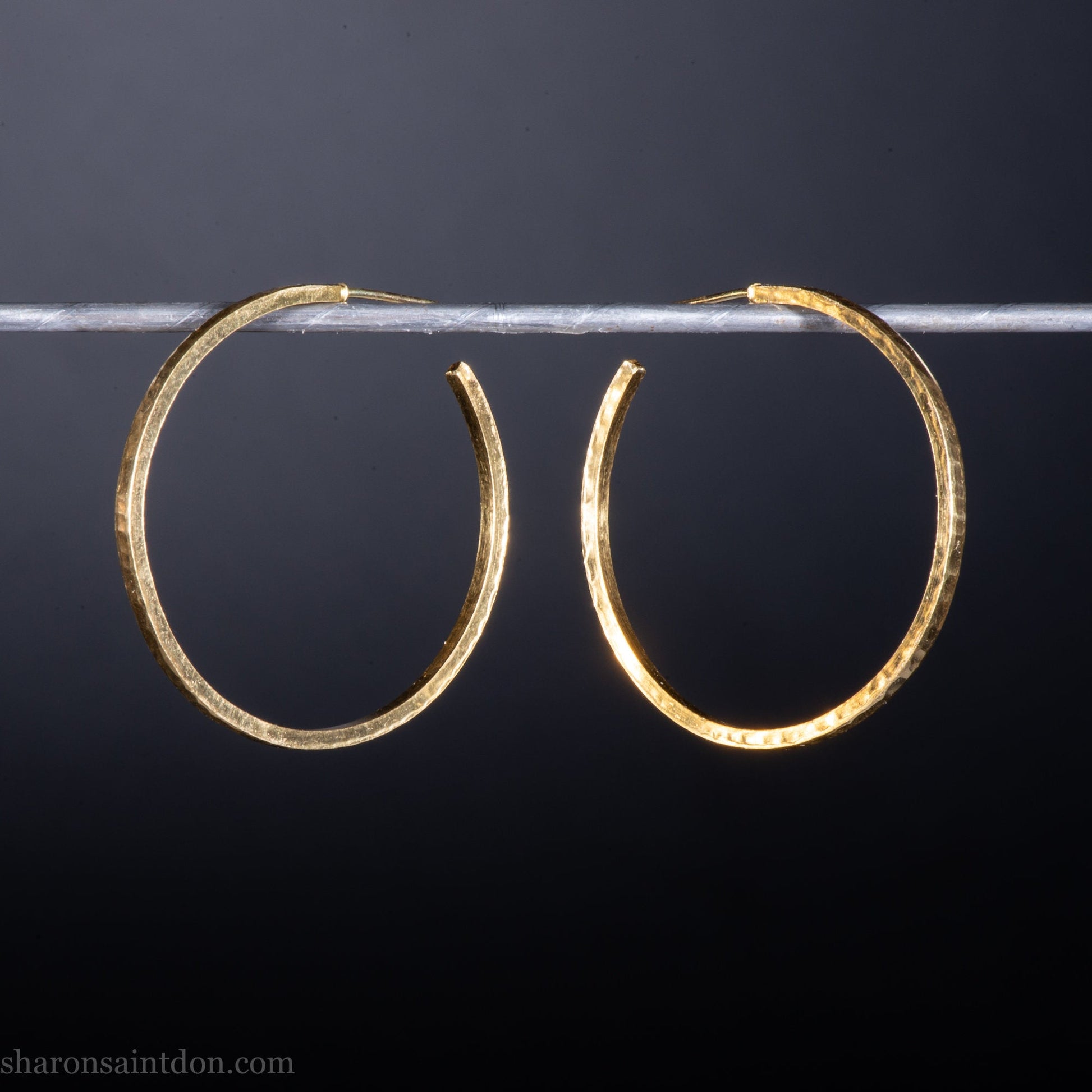 14k yellow gold hoop earrings 30mm diameter, 2mm wide, 1.5mm thick. High quality, handmade with hammered texture, solid gold posts and locking backs.