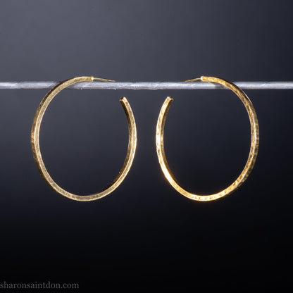 14k yellow gold hoop earrings 30mm diameter, 2mm wide, 1.5mm thick. High quality, handmade with hammered texture, solid gold posts and locking backs.