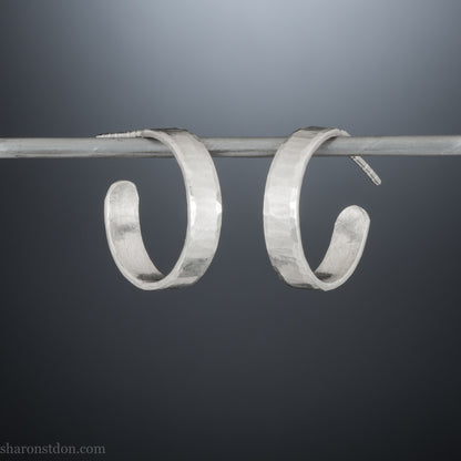 925 sterling silver hoop earrings handmade in North America by Sharon SaintDon. 18mm diameter round, 4mm wide, hammered texture, matte, brushed finish and silver posts and backs.