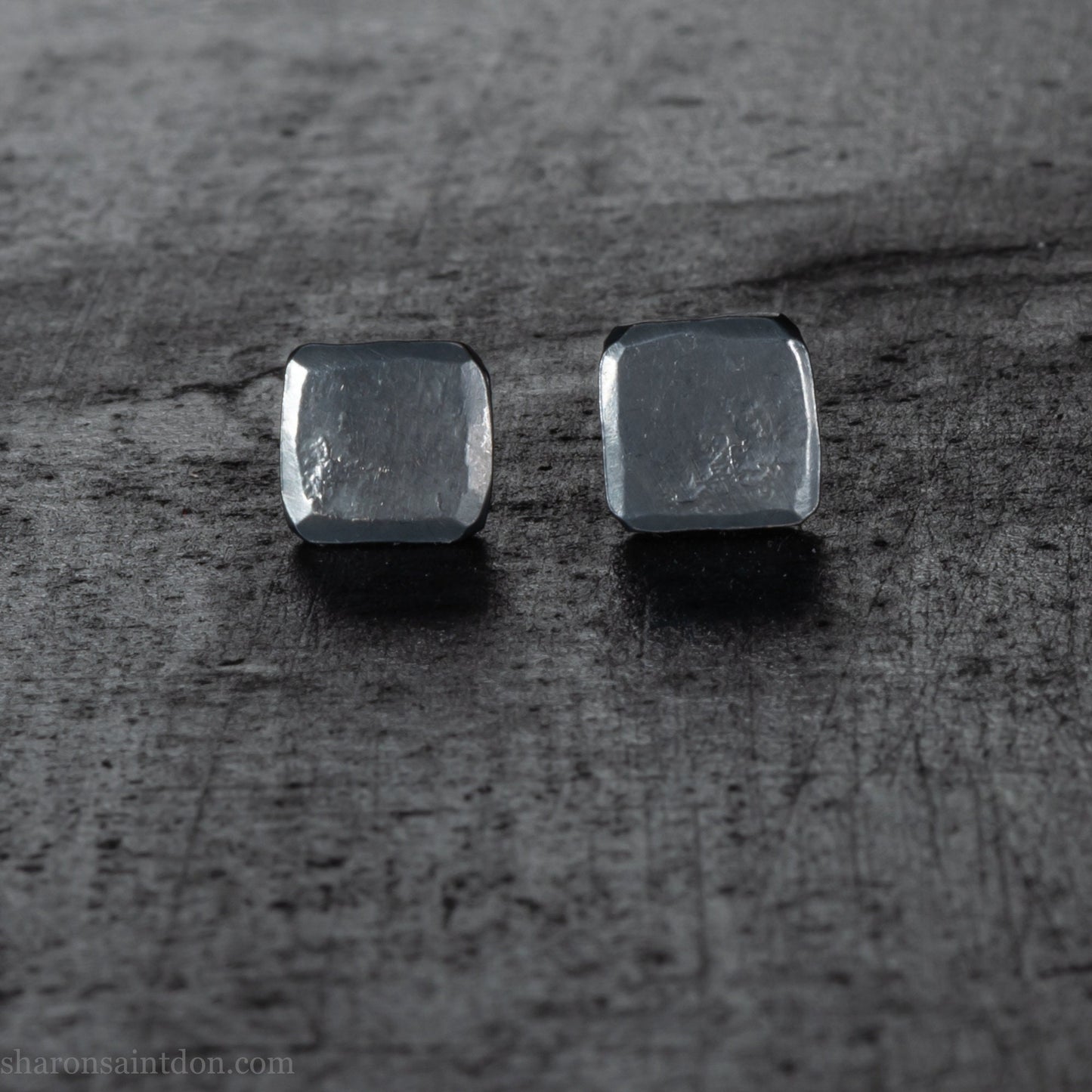 Handmade 925 sterling silver stud earrings.  Small hammered, textured squares. Minimalist, oxidized black stud earrings for men or women made by Sharon SaintDon in North America.