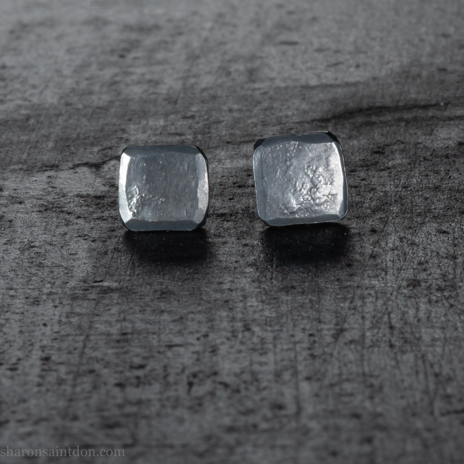 Handmade 925 sterling silver stud earrings.  Small hammered, textured squares. Minimalist, oxidized black stud earrings for men or women made by Sharon SaintDon in North America.