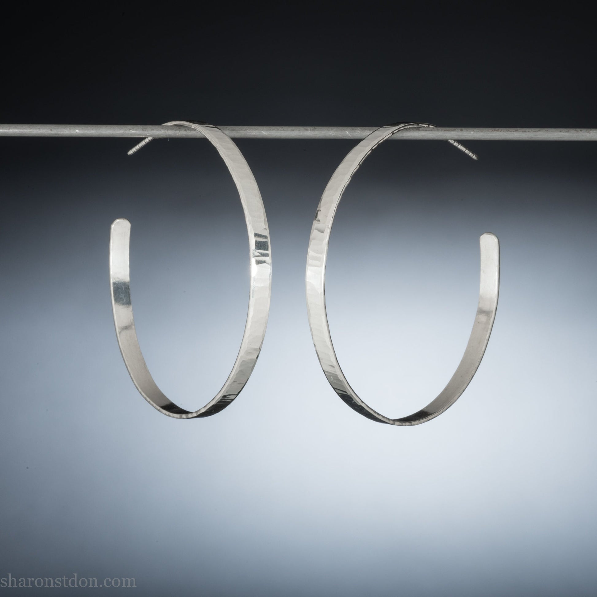 Handmade 925 sterling silver hoop earrings for women. Shiny hammered silver hoop earrings with wavy texture. 55mm diameter.