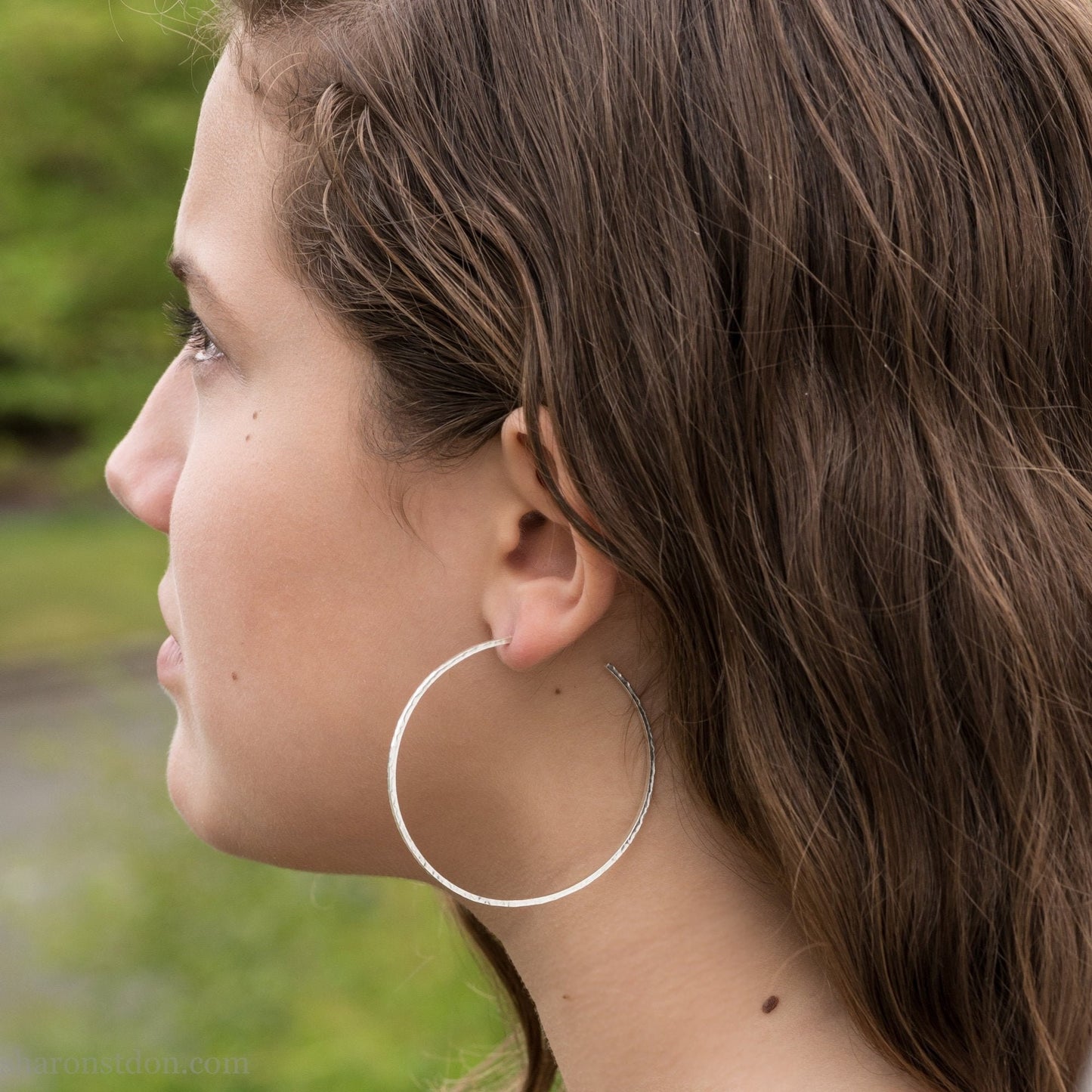 handmade 925 sterling silver hoop earrings for women. Comfortable, lightweight, daily wear earrings with a hammered, wavy texture.