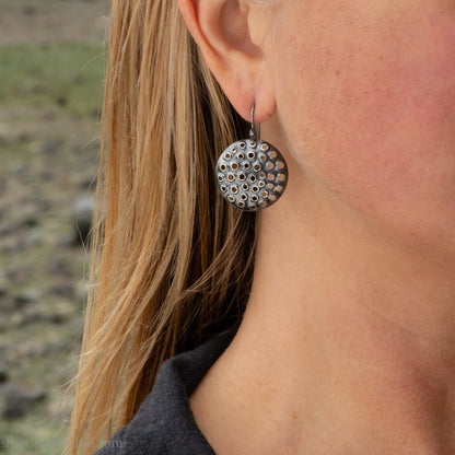 Handmade 925 sterling silver dangle earrings for women. Round disc earrings with perforated holes made by Sharon SaintDon in North America.