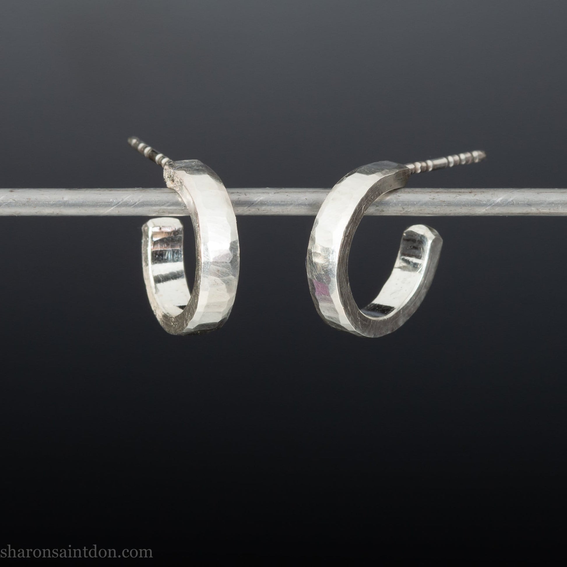 925 sterling silver hoop earrings handmade in North America by Sharon SaintDon. Small, shiny, 16mm x 3mm round with hammered texture.