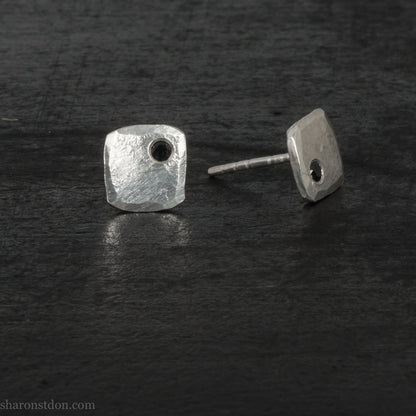 7mm square 925 sterling silver stud earrings with a black spinel gemstone in the corner. Hammered texture with a matte, brushed, shiny finish. Handmade by Sharon SaintDon in North America for men or women.