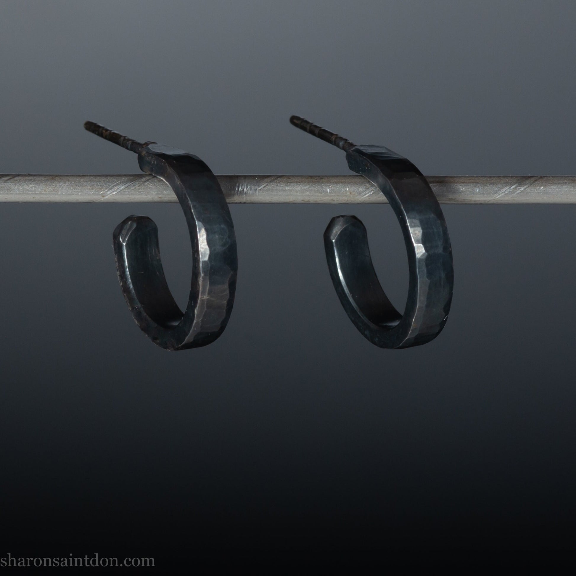 925 sterling silver hoop earrings for men or women, handmade in North America by Sharon SaintDon. 18mm diameter x 3mm wide, small, round, oxidized black with hammered texture.