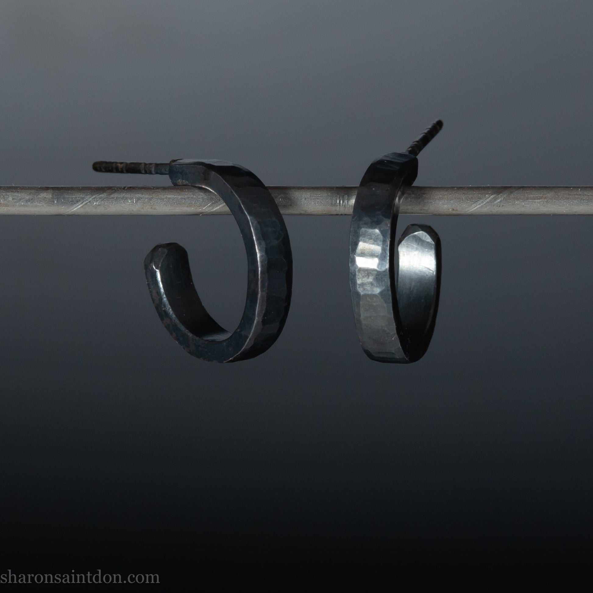 Handmade 925 sterling silver hoop earrings for men or women. 18mm x 3mm, round, oxidized black earrings with hammered texture, made by Sharon SaintDon in North America.