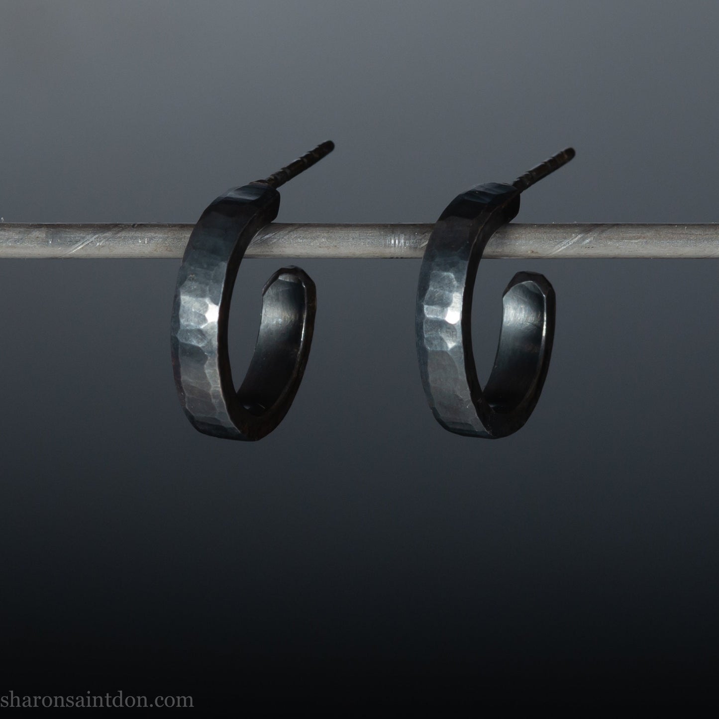 Handmade 925 sterling silver hoop earrings for men or women. 18mm x 3mm, round, oxidized black earrings with hammered texture, made by Sharon SaintDon in North America.
