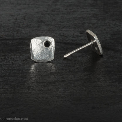 7mm square 925 sterling silver stud earrings with a black spinel gemstone in the corner. Hammered texture with a matte, brushed, shiny finish. Handmade by Sharon SaintDon in North America for men or women.