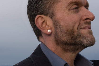 7mm square 925 sterling silver stud earrings with a black spinel gemstone in the corner. Hammered texture with a matte, brushed, shiny finish. Handmade by Sharon SaintDon in North America for men or women.