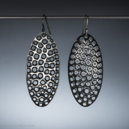 Large oval sterling silver dangle earrings with hand-punched detailed holes and antiqued finish.