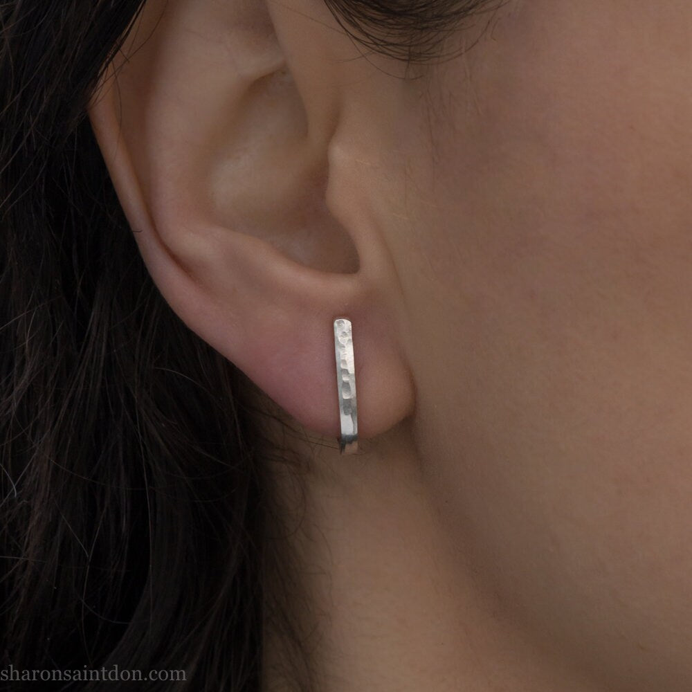 Men's solid 925 sterling silver J wrap huggie hoop earrings, matte finish, handcrafted, worn on ear.
