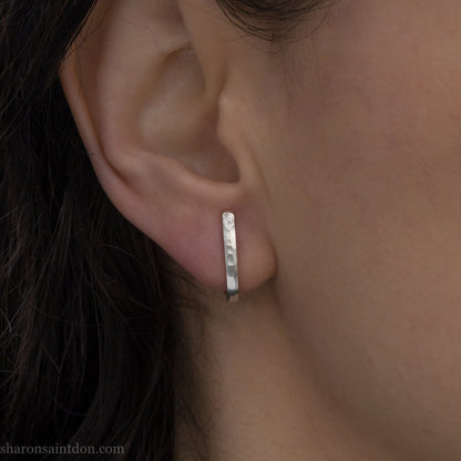 Men's solid 925 sterling silver J wrap huggie hoop earrings, matte finish, handcrafted, worn on ear.