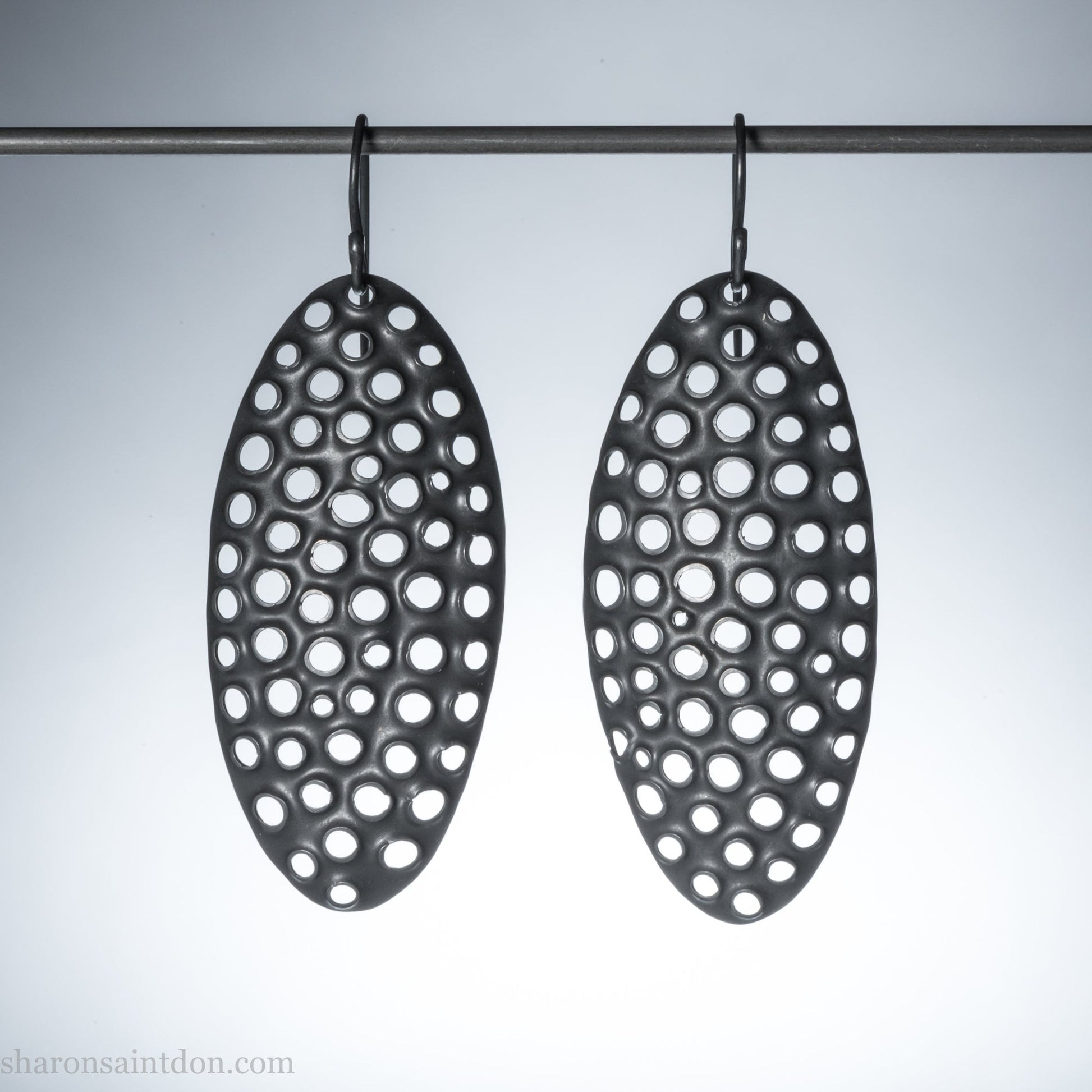 Oxidized sterling silver hand-punched dangle earrings, 50mm, dark charcoal matte patina, handmade by Sharon Saint Don.