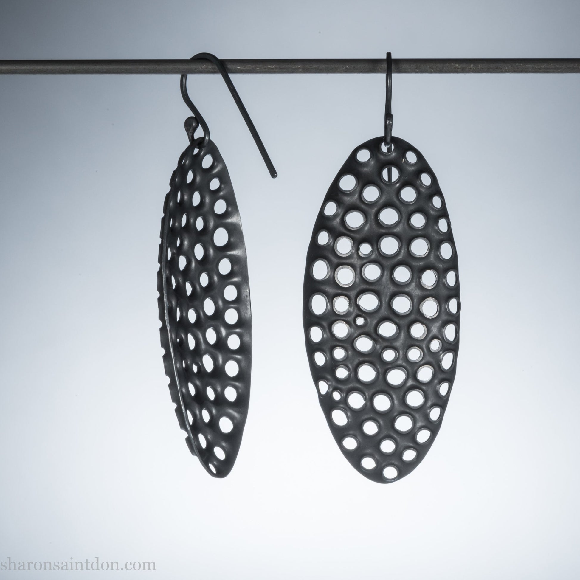 Oxidized sterling silver hand-punched dangle earrings, 50mm, dark charcoal matte patina, handmade by Sharon Saint Don.