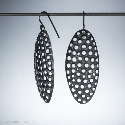 Oxidized sterling silver hand-punched dangle earrings, 50mm, dark charcoal matte patina, handmade by Sharon Saint Don.