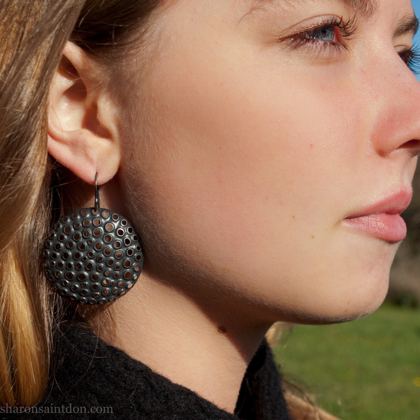 Lightweight 38mm round oxidized sterling silver dangle earrings handcrafted in Pacific Northwest, worn on ear.