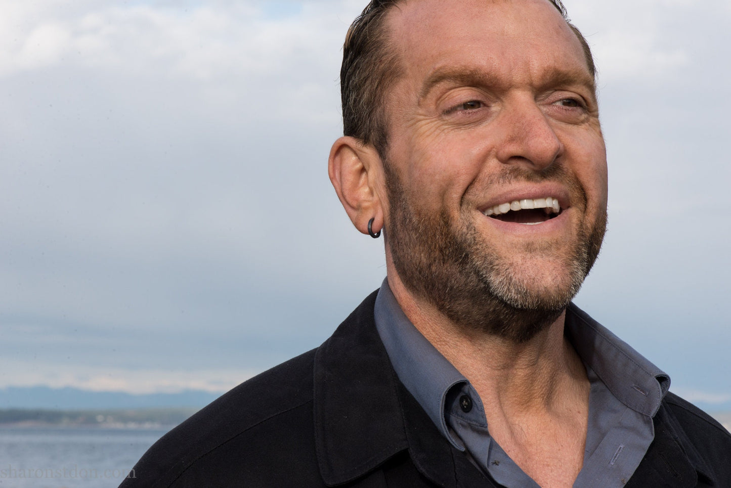 Small black hammered sterling silver hoop earrings worn by man, side profile, 14x2mm