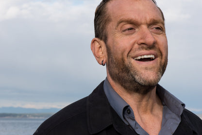 Small black hammered sterling silver hoop earrings worn by man, side profile, 14x2mm